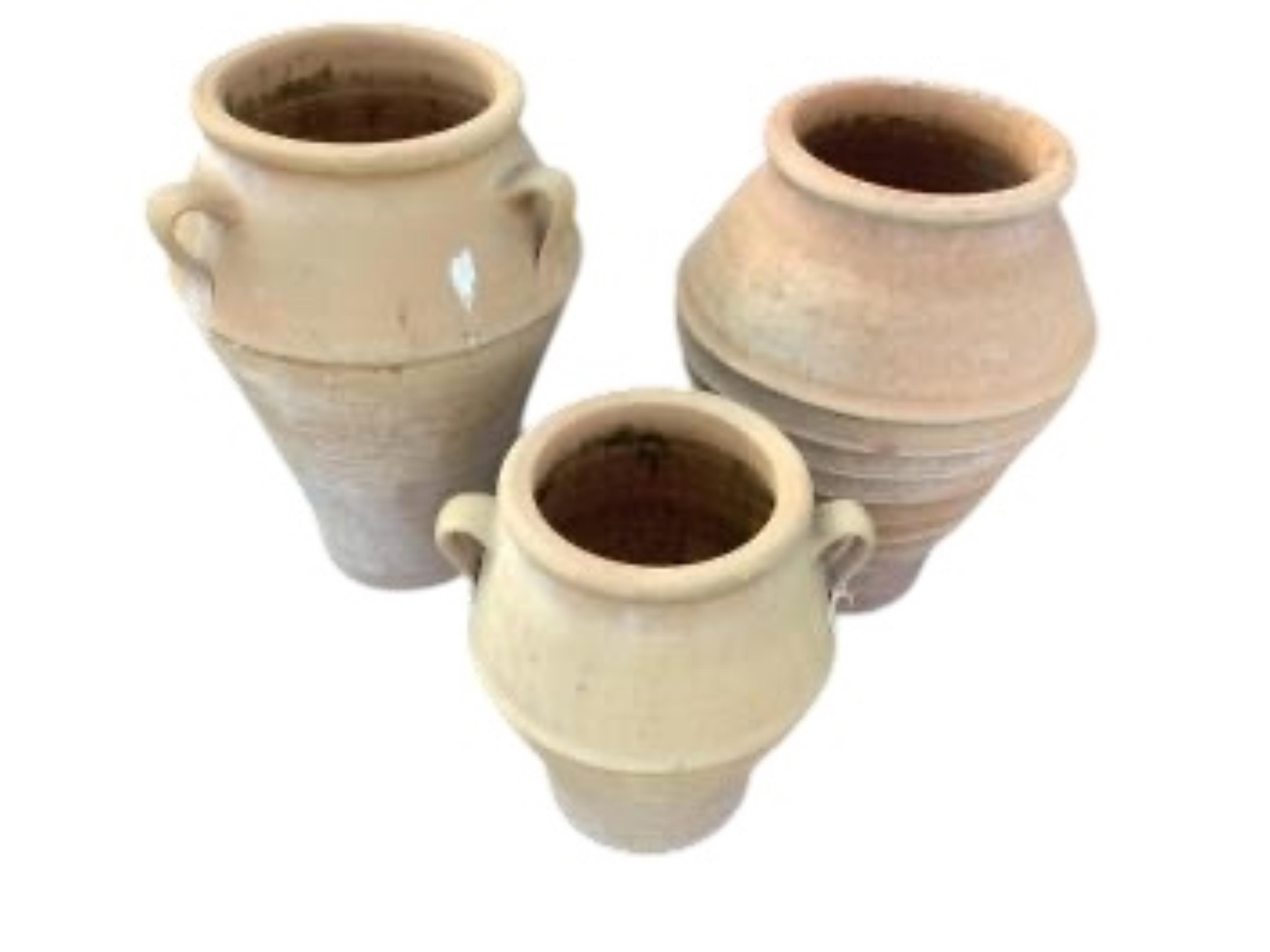 Three Grecian style circular terracotta garden planters, height 55cm